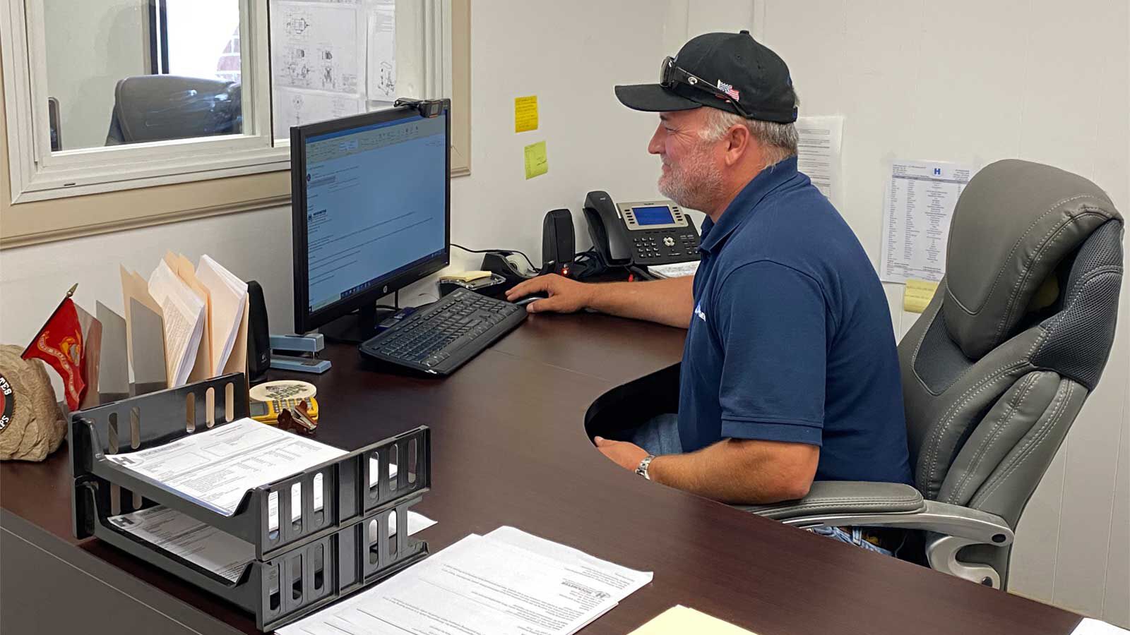 A Parts & Service employee answering emails from a client of Hockmeyer Equipment Corporation