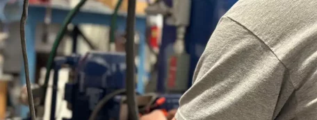A Hockmeyer employee works on maintenance of a NEXGEN immersion milling machine.