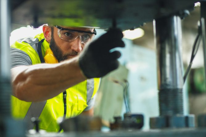 safety-man-cleaning-mill-in-factory