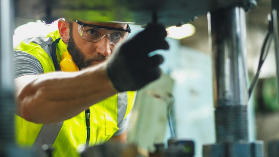 safety-man-cleaning-mill-in-factory